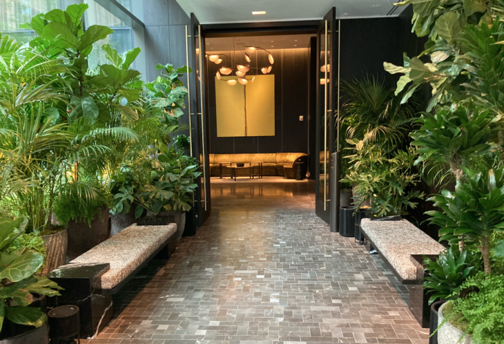 a hallway with benches and plants