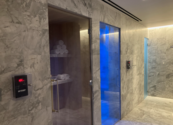 a glass door with a blue light in the middle of a room