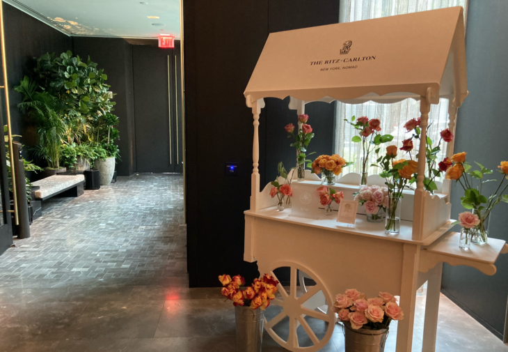 a flower cart with flowers in buckets