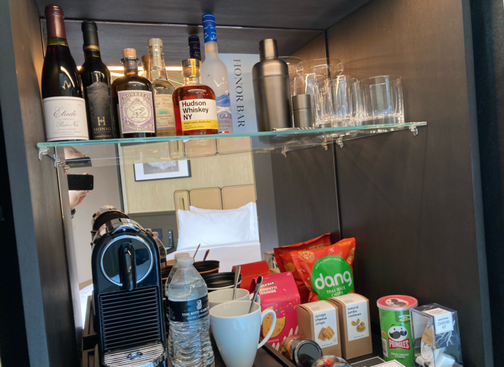 a shelf with bottles and cups on it