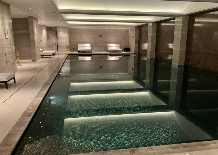 a indoor pool with white chairs