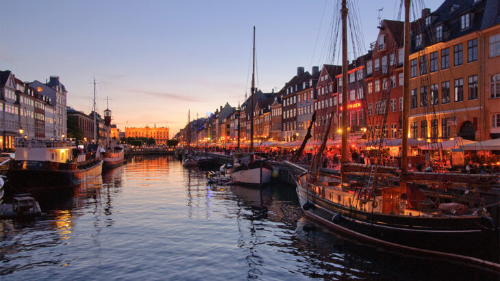 a water with boats and buildings in the background